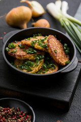 Delicious onion  fritters with sour cream and green onion on plate, closeup