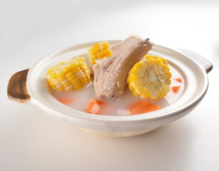 double boiled pork ribs with corn and carrot hot soup in hot clay pot asian Chinese menu