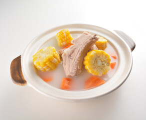 double boiled pork ribs with corn and carrot hot soup in hot clay pot asian Chinese menu
