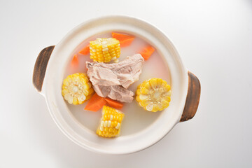 double boiled pork ribs with corn and carrot hot soup in hot clay pot asian Chinese menu