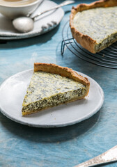 Quiche with spinach - traditional dish of french cuisine. Spinach  tart