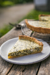 Quiche with spinach - traditional dish of french cuisine. Spinach  tart