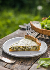 Quiche with spinach - traditional dish of french cuisine. Spinach  tart