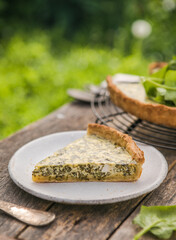 Quiche with spinach - traditional dish of french cuisine. Spinach  tart