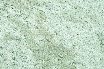 celadon green concrete old wall. cement texture. scuffs and cracks