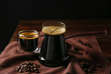 Pot and cup with hot turkish coffee on dark background