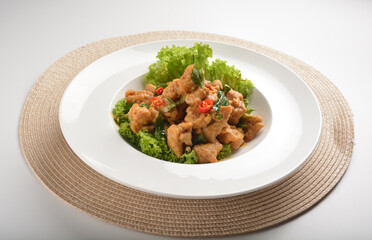 deep fried crispy chicken cube with salted egg yolk paste spicy sauce and curry leaf in plate on white table asian cafe restaurant halal menu