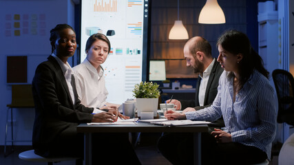 Pov of diverse businesspeople analyzing company strategy discussing corporate statistics during online videocall conference. Multi ethnic teamwork working in meeting room brainstorming ideas