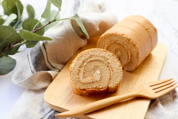 Coffee roll cake with cream , Espresso roll cake served on the wooden tray at close up view 