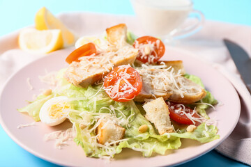 Plate with fresh Caesar salad on color background, closeup