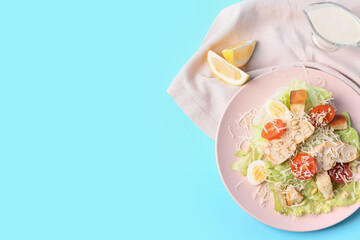 Plate with fresh Caesar salad on color background