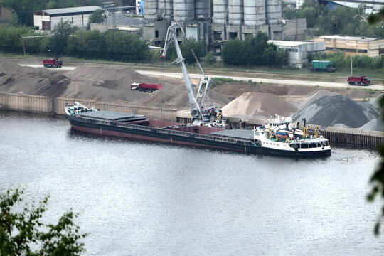 Barge on the river Unloading river sand from a barge Navigable river, river port. High quality photo