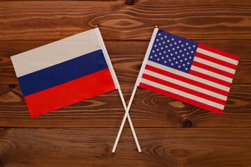 Flag of Russia and flag of USA crossed with each other. The image illustrates the relationship...