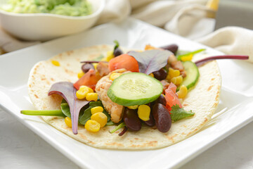 Plate with tasty taco on light background, closeup
