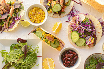 Composition with tacos and ingredients on light background