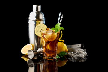Glass of Fresh Long Island Ice Tea Cocktail - studio shot on black background