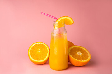 Glass of orange juice surrounded by fruit. Orange straw, slice of citrus fruit