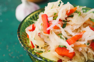 Bowl with tasty sauerkraut on color background, closeup