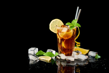 Glass of Fresh Long Island Ice Tea Cocktail - studio shot on black background