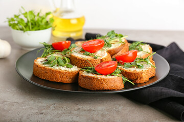 Plate with tasty toasts on grunge background