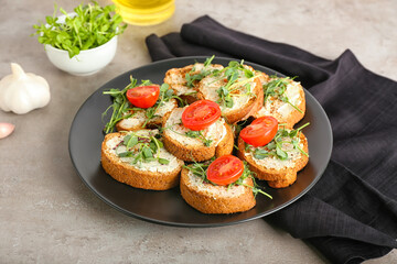 Plate with tasty toasts on grunge background