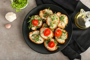 Plate with tasty toasts on grunge background
