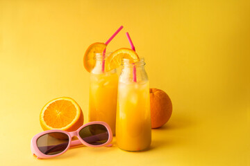 Mason jar of fresh orange juice on color background