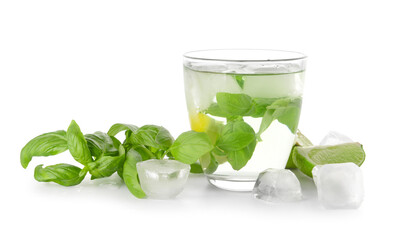 Glass of lemonade with basil on white background