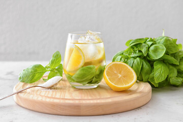 Glass of lemonade with basil on light background - obrazy, fototapety, plakaty