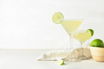 Glasses with tasty daiquiri cocktail on light background