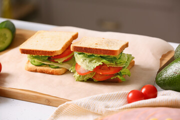 Tasty sandwiches on table in kitchen