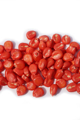 Red Corn seeds isoolated on white background. Red Chemically treated corn seed ready for planting 