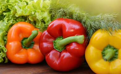 Colorful sweet bell peppers, salad, dill on wooden background.Healthy vegetarian food.Vegetarian eating concept.