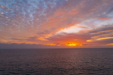 Sunrise over the sea and beautiful cloudscape. Colorful ocean beach sunset.