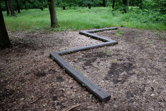 zigzag on the ground in the forest is installed wooden beam for children and athletes, as a training of physical stability, is part of the training ground