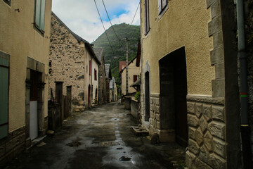 Fototapeta na wymiar Calle angosta en el pequeño pueblo de Urdos, en el Pirineo francés. Casas con la arquitectura tradicional de los pequeños pueblos del Pirineo francés.