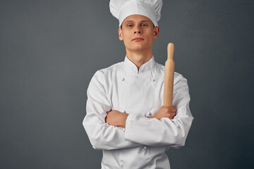 chef holding a rolling pin in his hands cooking professionals