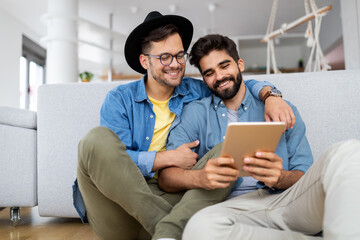 Happy gay couple embraced, joking and having fun in an intimate hug