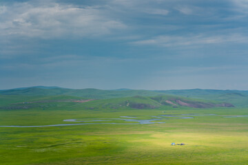 A river winding up on the Hulunbuir Grasslands, in Inner Mongolia, China, summer time.