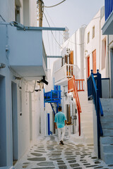 Mykonos Greece, Young man at the Streets of old town Mikonos during a vacation in Greece, Little...