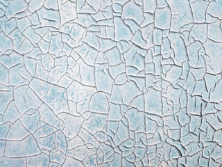 The texture of a painted white and blue wall that has cracked. Concept background, texture