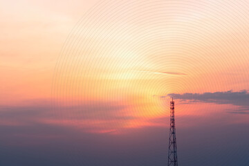 A view of the signal tower at sunset in vibrant orange pinks and violet colors