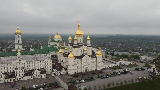Aerial view to largest Orthodox church complex and monastery - The Dormition Pochayiv Lavra was founded on a mountain near the town of Novy Pochaev in 1240, Ukraine. May 2021