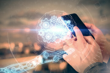 Double exposure of man's hand holding and using a digital device and data theme hologram drawing. Technology concept.