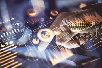 Double exposure of man's hands holding and using a digital device and tech theme hologram drawing. Technology concept.