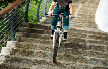 Woman freerider riding down stairs. Sports extreme and active lifestyle