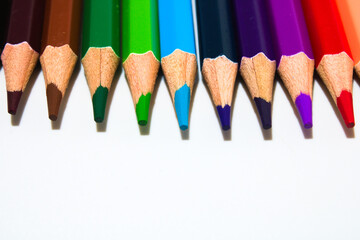 Close up of sharp coloured pencils isolated on white background with copy space