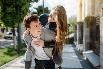 Young happy beautiful couple in the street.