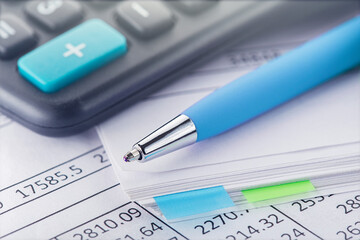 accounting document with pen and calculator. Concept of banking, financial report and financial audit.