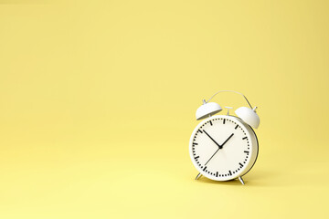 3d rendering . White vintage alarm clock with a bright yellow background. Minimal creative idea concept.